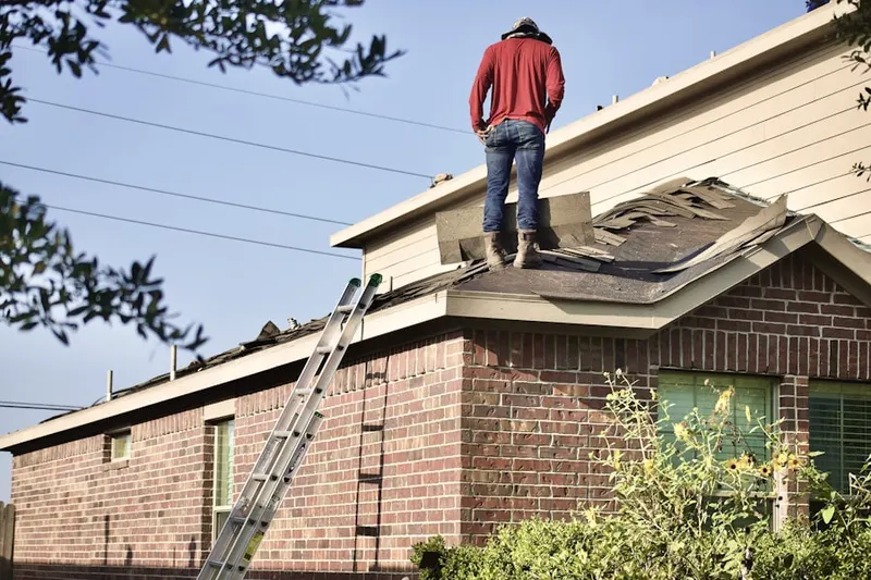 Professional roofer working on a residential roof in Earle